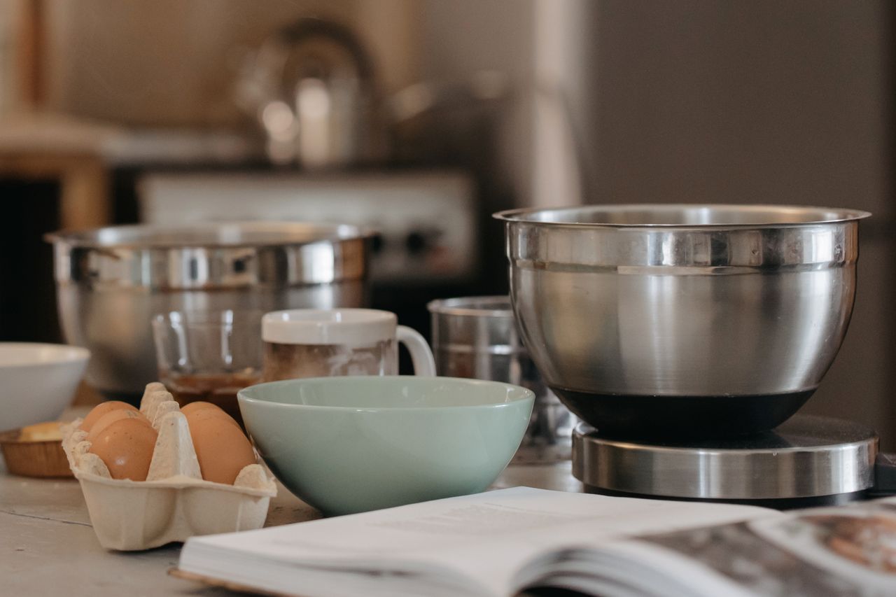 programs-02 A cozy kitchen setup with baking bowls, eggs, and kitchen utensils for a comforting cooking experience.