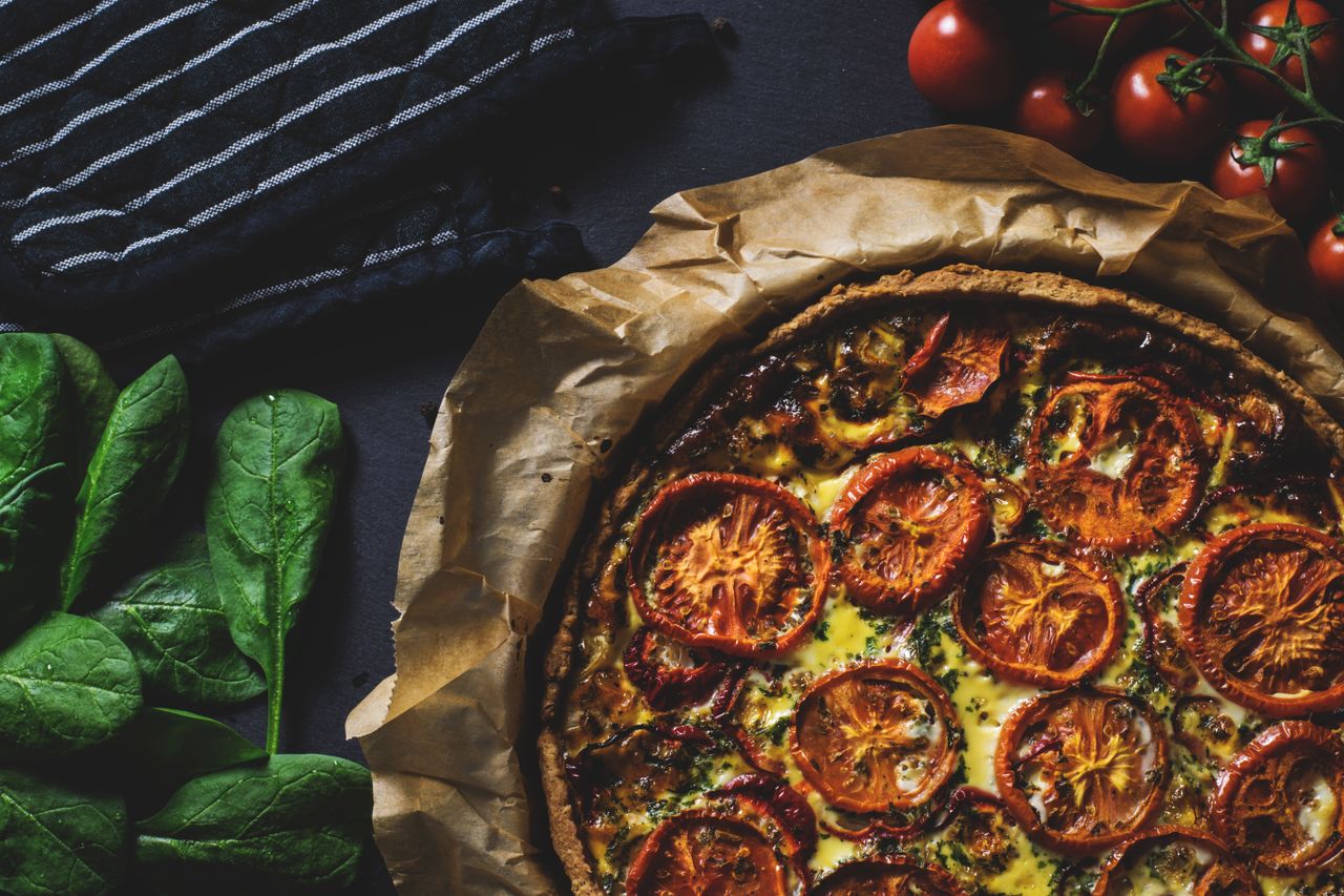 hero-gallery-02 Delicious rustic quiche topped with tomatoes, ideal for a healthy and tasty meal.